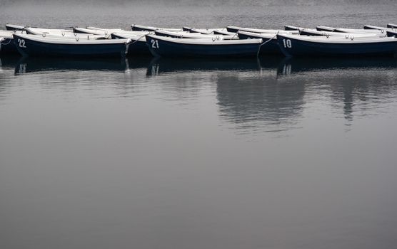 Boats on lake in gray overcast weather