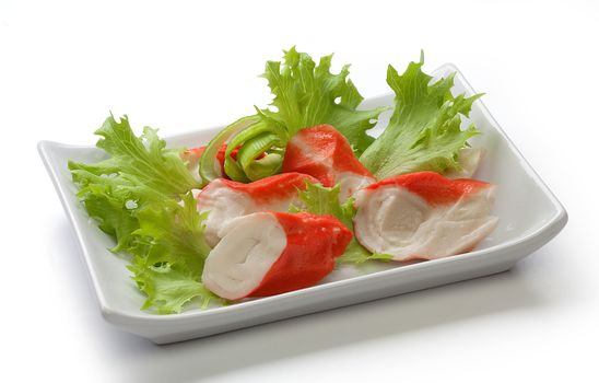 Crab meat with fresh green lettuce on the plate