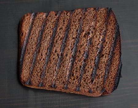 Top view of toasted custard rye brad on the black wooden table