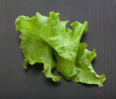 Top view of green fresh lettuce on the black wooden table