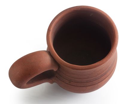 Top view of isolated brown clay mug on the white baclground