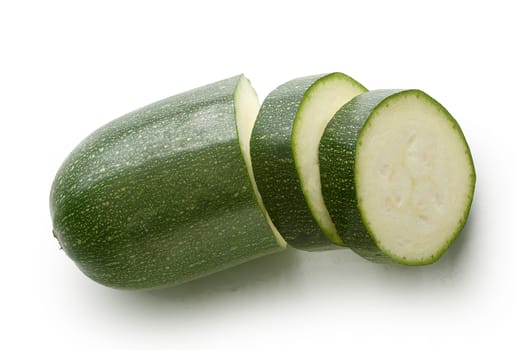 Top view of sliced piece of green zucchini on the white background