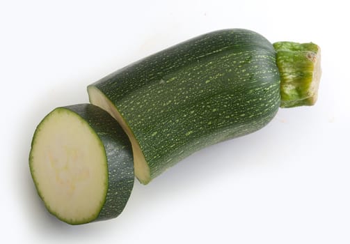 Isolated pieces of green zucchini on the white background