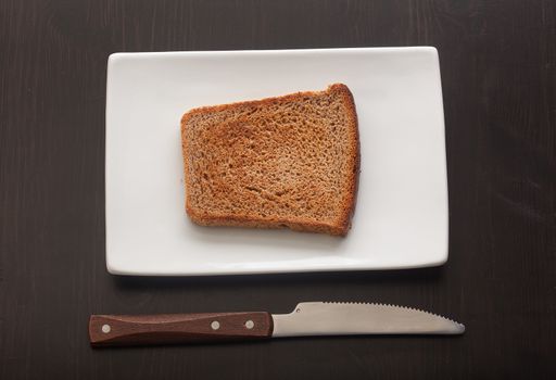 Top view of toasted rye bread on the white plate