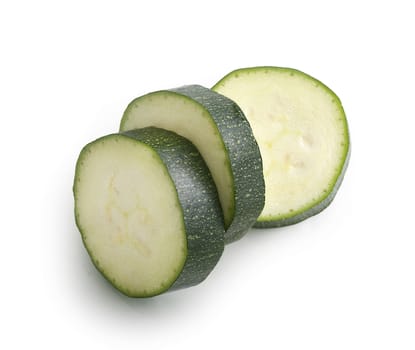 Top view of slices of green zucchini on the white background