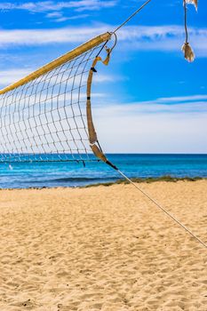 Sand beach volleyball net at seaside coast