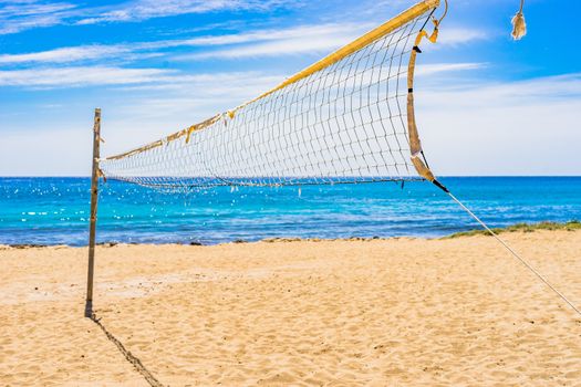 Volleyball net on sand beach at seaside coast