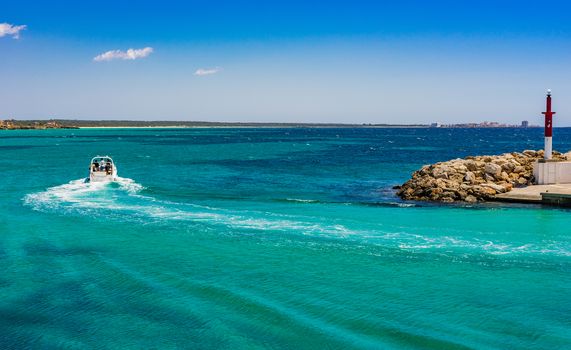 Idyllic view of luxury motorboat yacht driving in turquoise blue sea water