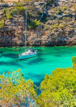 Beautiful bay with anchoring sailboat yacht at the seaside on Mallorca island, Spain Mediterranean Sea