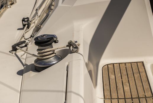 Close-up of winch with nautical rope on boat deck of old sailing yacht