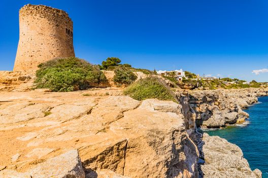 View of the old watch tower Torre de Cala Pi on Majorca island, Spain Mediterranean Sea