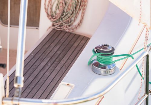 Winch with nautical rope on boat deck of boat yacht