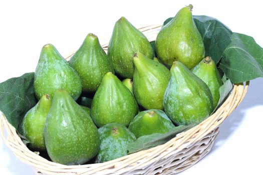 Figs on wicker basket isolated on white