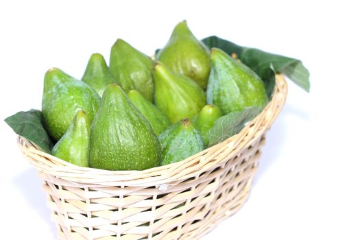 Figs on wicker basket isolated on white