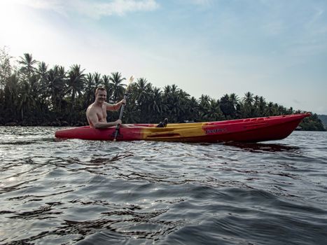 Cambodia, Ko-Hong - March 2016: Caucasian man, mid 40`s kayaking through the cambodian Jungle on the River Kong