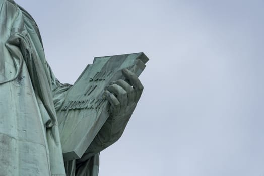 USA, New York - May 2019: Book Held by showing 4th of July, Statue of Liberty, Liberty Island
