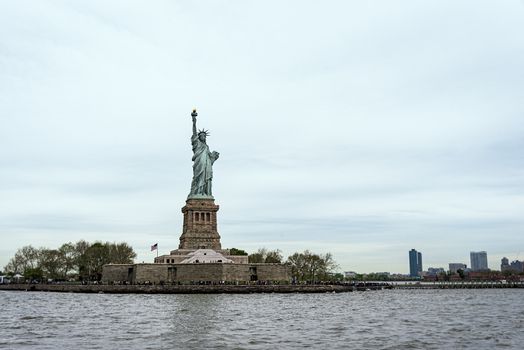 USA, New York - May 2019: Statue of Liberty, Liberty Island, with Manhtattan in the background