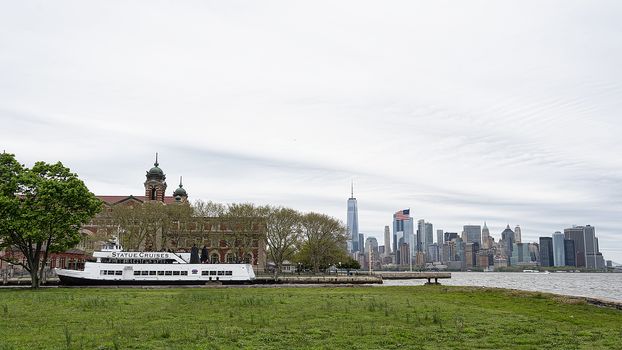 USA, New York - May 2019:  Manhattan , Ellis Island and a ferry boat