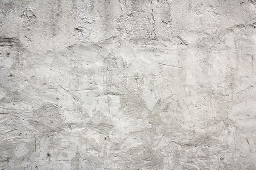Old white concrete wall with plaster, grungy background.