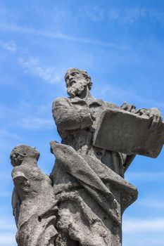 Statue of an old teacher with mutilated hand and his student.