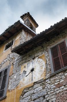 Medieval clock on a facade of house