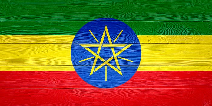 Ethiopia flag painted on old wood plank background. Brushed wooden board texture. Wooden texture background flag of Ethiopia