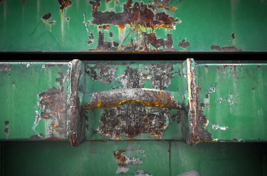 Details of an old dumpster with big rusty handle