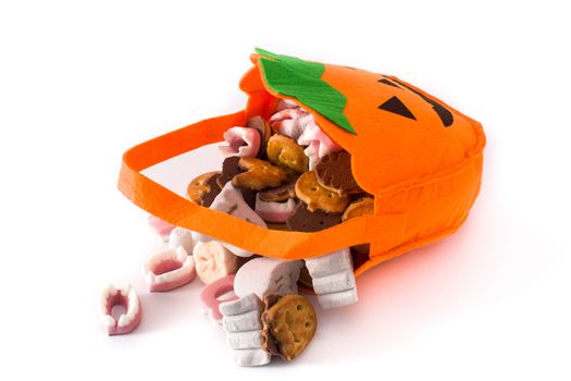 Halloween pumpkin bag with candies inside isolated on white background