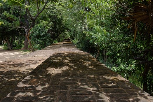 Polonnaruwa, Sri lanka, Sept 2015: This stone walls around the site of the ruins at Polonnaruwa are now shaded paths for tourists