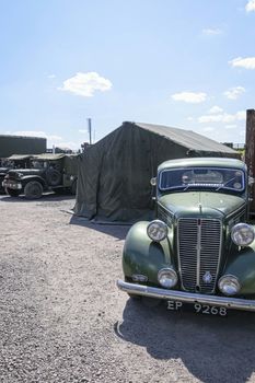 UK, Quorn - June 2015: Vintage military vehicles parked outside of army tents	