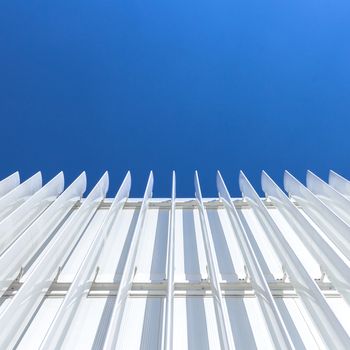 Abstract perspective of the facade of a modern building covered with white panels