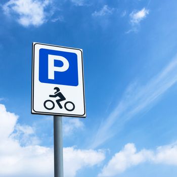 Motorcycles only sign against blue sky, with copy space for background.