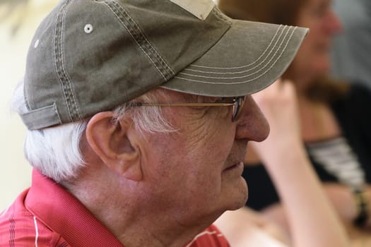 UK, Leicestershire - June 2015: Elderly man wearing baseball cap - side view