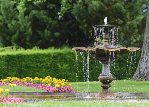 France, Alsace, June 2015: antique fountain in public garden