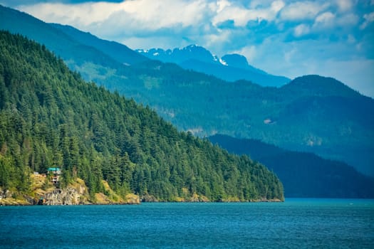 Harrison lake overview with residential house on the shore.