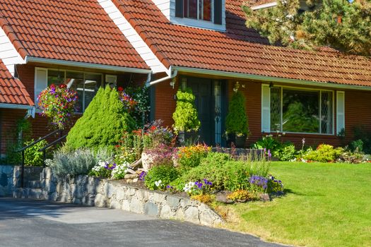 Entrance of residential house with tiled roof and delicately landscaped front yard