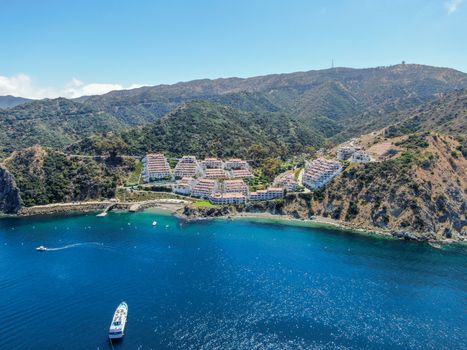 Aerial view of Hamilton Cove with apartment condo building on the cliff, Santa Catalina Island, famous tourist attraction in Southern California, USA