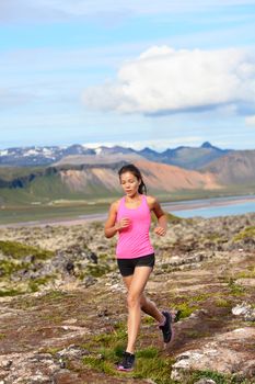 Athlete runner woman running in nature. Female fitness girl cross country trail running in amazing nature landscape outside. Image from Iceland.