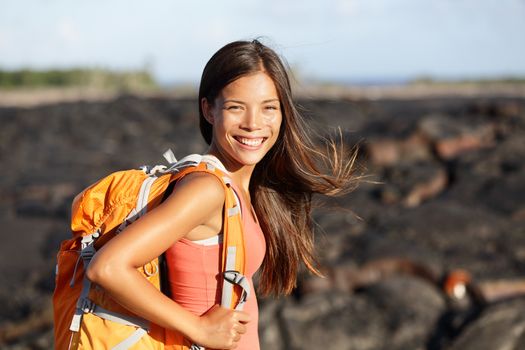 Hiking woman - hiker walking on lava field on Hawaii. Tourist on hike near Kilauea volcano around Hawaii volcanoes national park, USA.