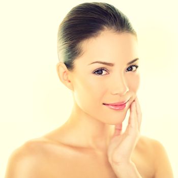 Woman beauty skincare woman touching perfect skin on face. Beautiful wellness beauty care and spa concept with multi-ethnic Chinese Asian / Caucasian girl with healthy glowing skin.