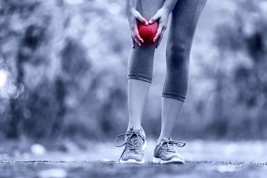 Knee Injury - sports running knee injuries on woman. Female runner with pain from sprain knee. Close up of legs, muscle and knee outdoors.