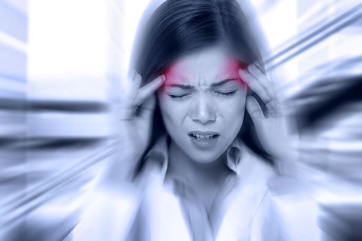 Headache migraine people - Doctor woman stressed. Woman Nurse / doctor with migraine headache overworked and stressed. Health care professional in lab coat wearing stethoscope at hospital.