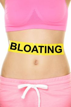 Bloating in stomach abdomen. BLOATING text written on female stomach. Bloated due to food diet conceptual image.