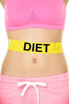 Diet and healthy eating concept - woman stomach showing DIET text written on female belly. Dieting concept showing slim fit female abdomen.