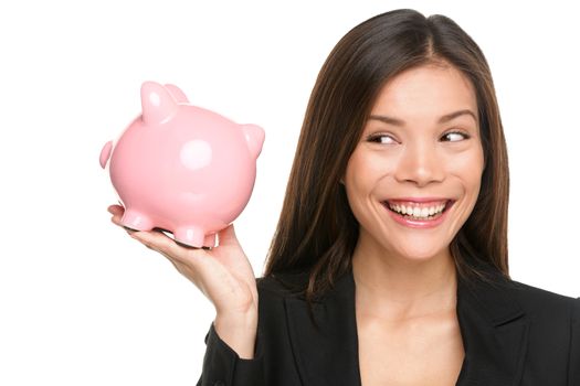 Piggy bank savings woman smiling happy. Female business woman holding pink piggy bank isolated on white background. Multi-ethnic Chinese Asian / Caucasian girl.