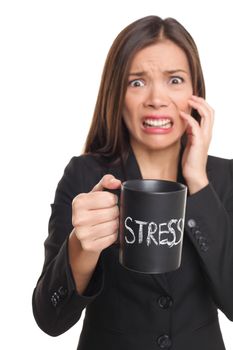 Stress concept. Business woman stressed being too busy. Businesswoman in suit holding head drinking coffee creating more stress. Mixed race Asian Caucasian female isolated on white background.