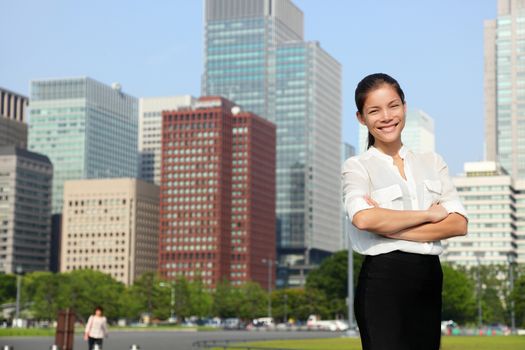 Businesswoman in Tokyo city skyline, Japan. Beautiful young casual professional woman standing portrait for Japanese business concept in Japan.