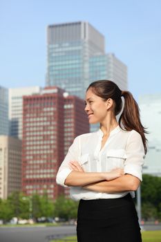 Asian businesswoman happy in urban Tokyo city, Japan, Asia. Japanese looking woman portrait for business concepts standing near Ginza district in Tokyo.