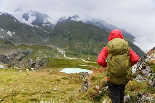 Hiking - hiker woman on trek with backpack living healthy active lifestyle. Hiker girl walking on hike in mountain nature landscape in Steingletscher, Urner Alps, Berne, Swiss alps, Switzerland.