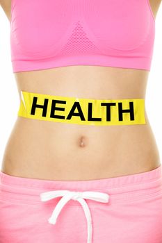 Health warning on stomach body - diet or nutrition concept. Word written on yellow label on lower body abdomen of female young adult to show caution about our health.